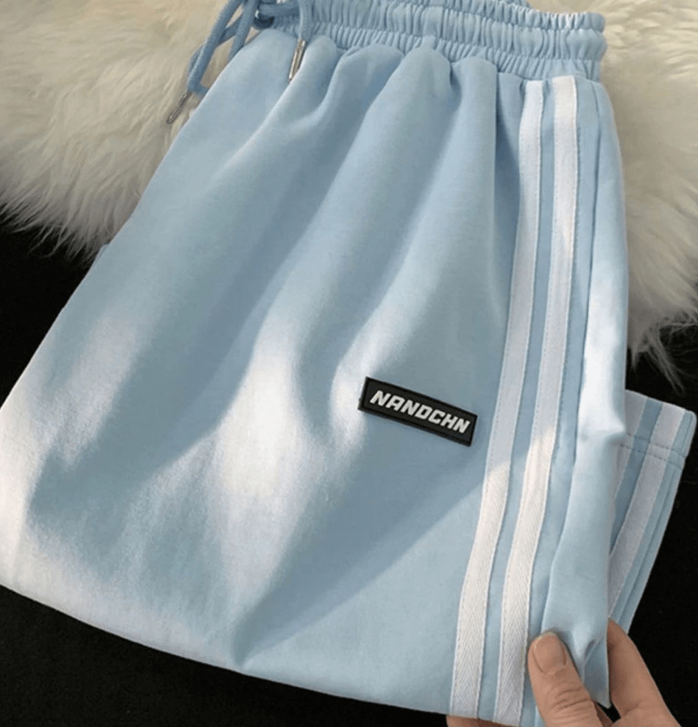 Light blue casual women's shorts with elastic waistband and side stripes, designed for active wear and comfort.