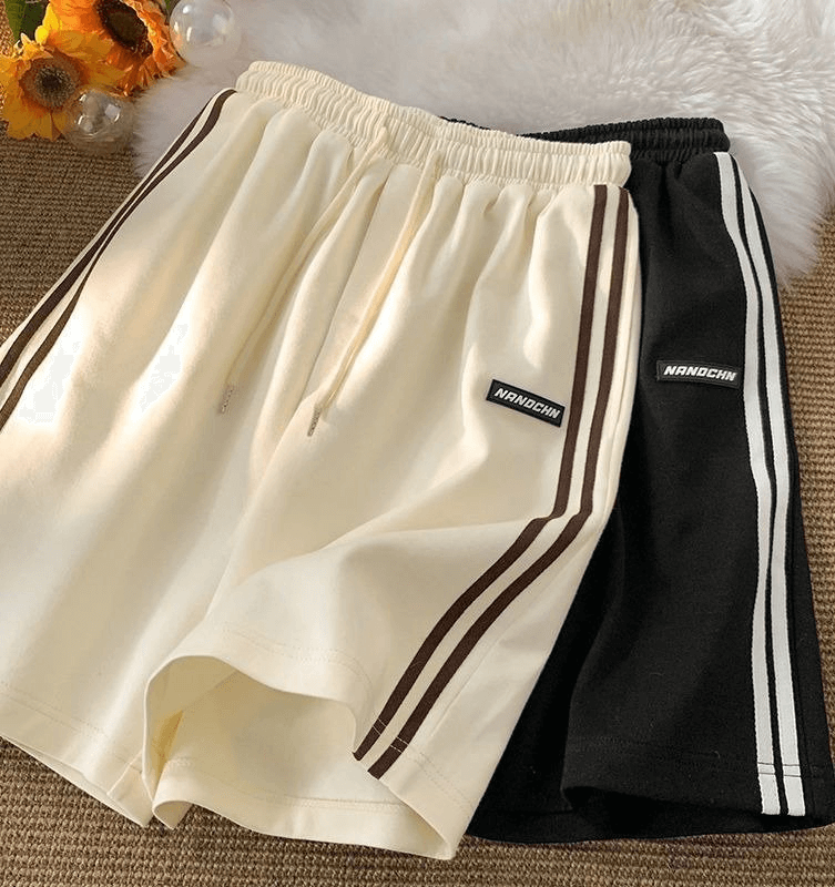 Wide sport casual women's shorts with elastic, beige and black with stripe design, perfect for active wear.