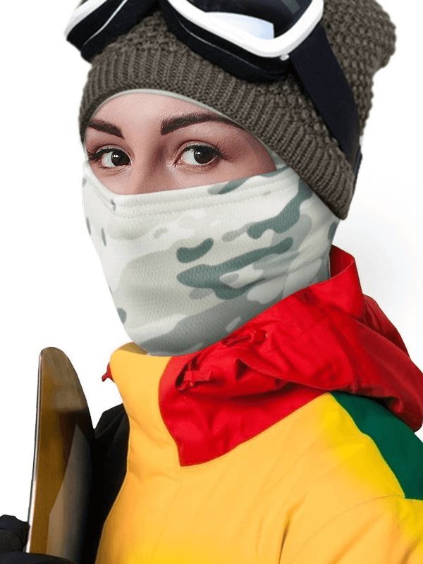 Person wearing a windproof camouflage balaclava and holding snowboard, ideal for outdoor winter activities.