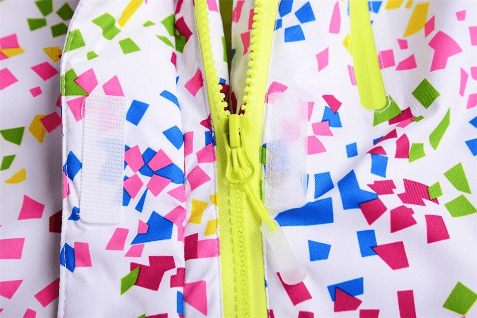 Close-up of multicolor skiing jacket with windproof zipper and confetti pattern, designed for women in vibrant colors.