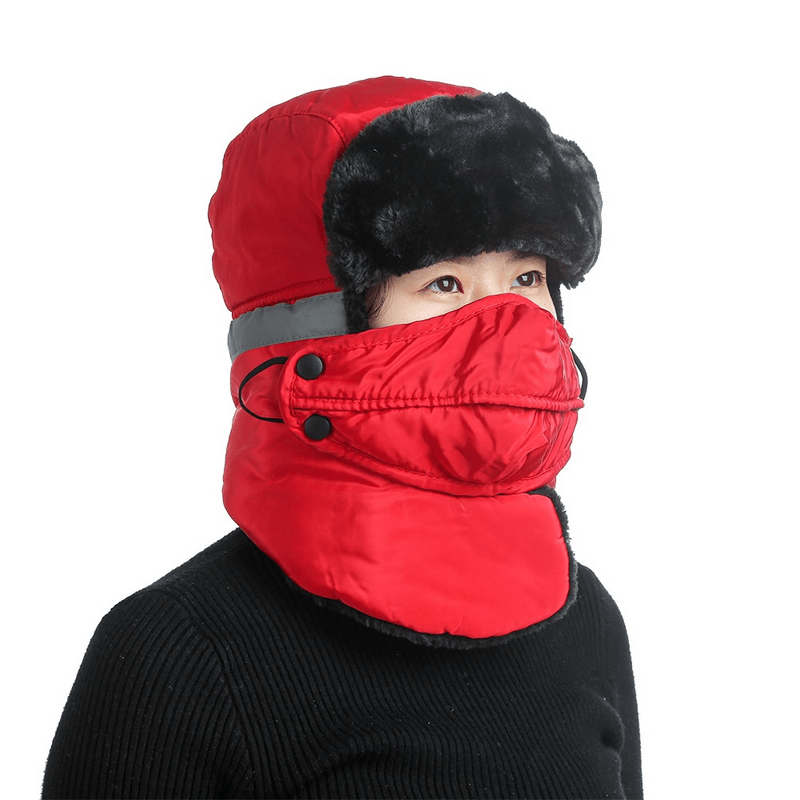 Person wearing red windproof mountain ski cap with earflap and closed neck, ideal for winter skiing and cold weather protection.
