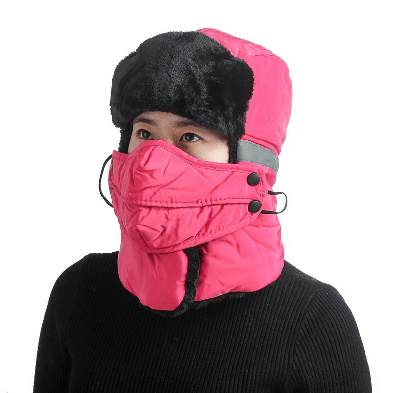 Winter windproof ski cap with earflap and closed neck, unisex design in pink. Perfect for cold mountain adventures. Model wearing the cap.