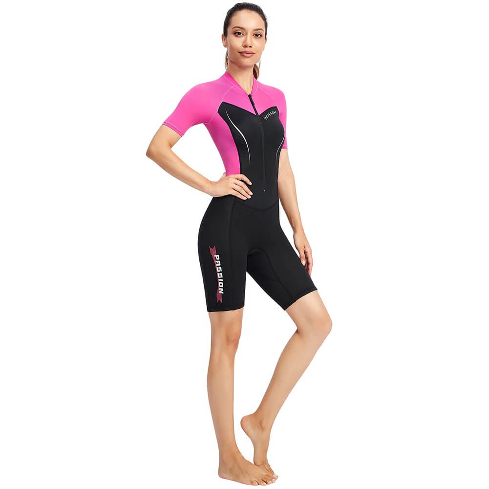 Woman wearing a pink and black 1.5mm neoprene wetsuit for surfing and diving, providing warmth and jellyfish sting protection.