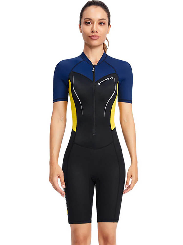 Woman wearing a 1.5mm neoprene wetsuit for surfing and diving, featuring a sleek design with blue, yellow, and black panels, front view.