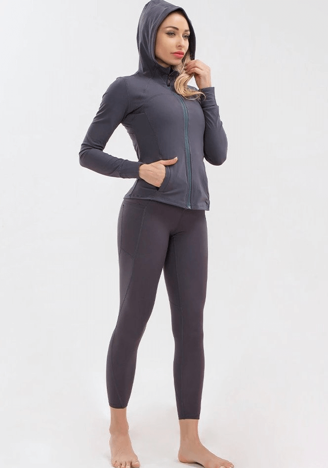 Woman wearing long-sleeve quick-drying sports shirt and leggings, ideal for yoga and activewear.