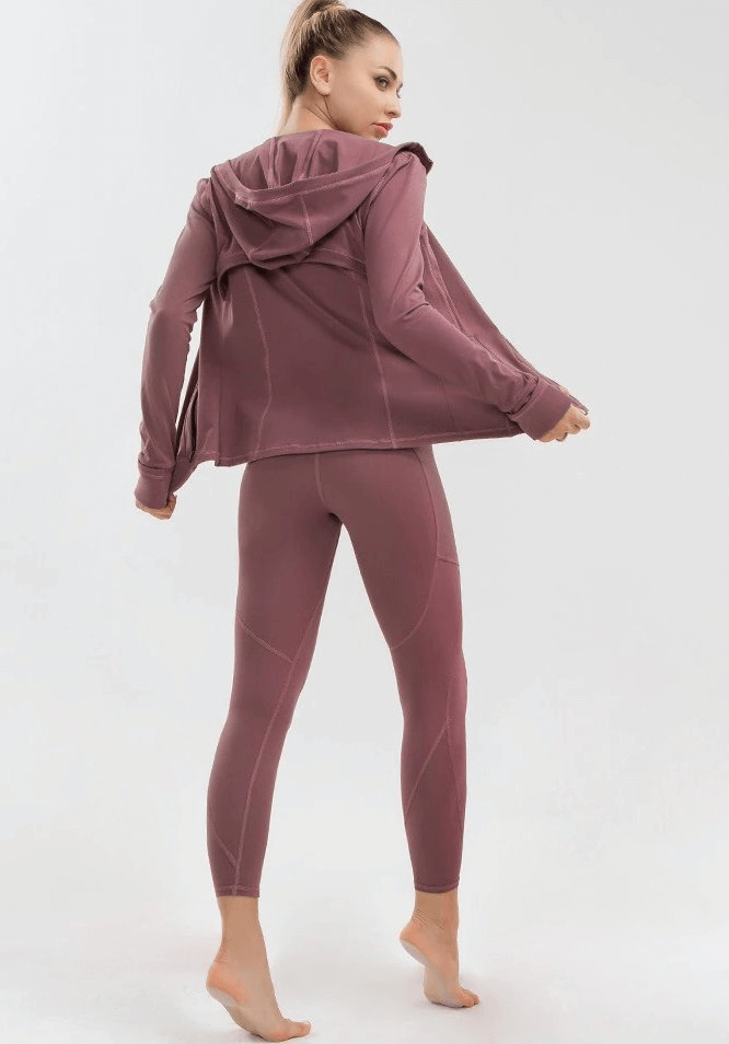 Woman in mauve quick-drying long-sleeve sports shirt and leggings, perfect for yoga and active lifestyle.