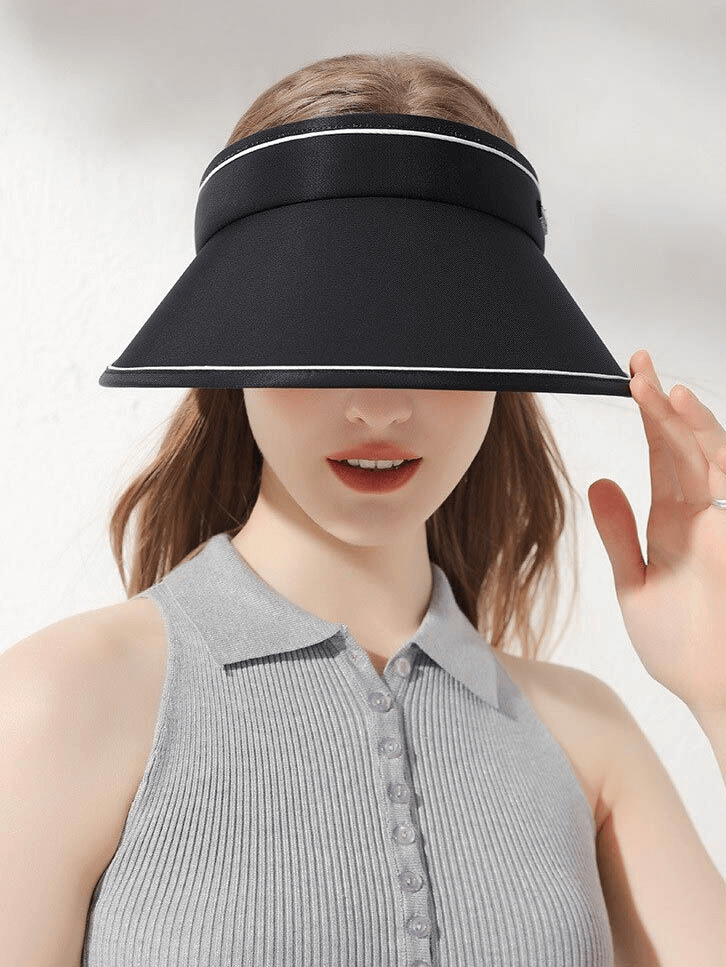 Woman wearing black adjustable sun proof visor foldable sun hat, stylish outdoor sun protection cap.
