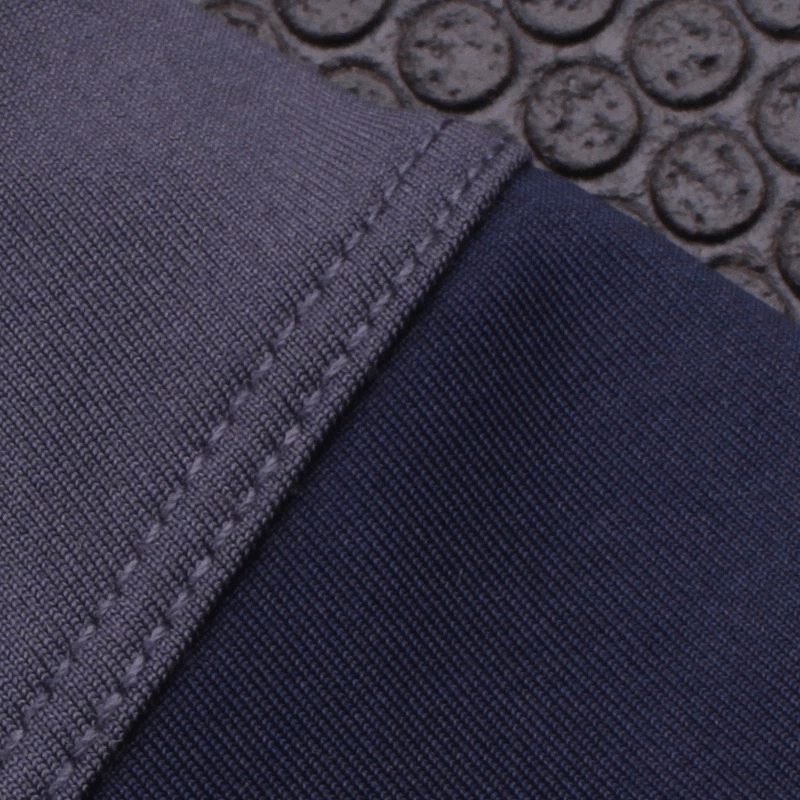 Close-up of Women's Breathable Tennis Skirt-Shorts fabric texture in deep gray, showcasing durable and comfortable material.