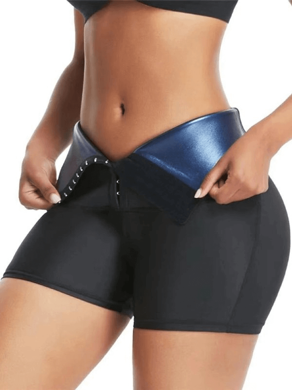 Women's compression sports shorts with sauna effect, black high-waist style, showing flexibility and comfort for active wear.