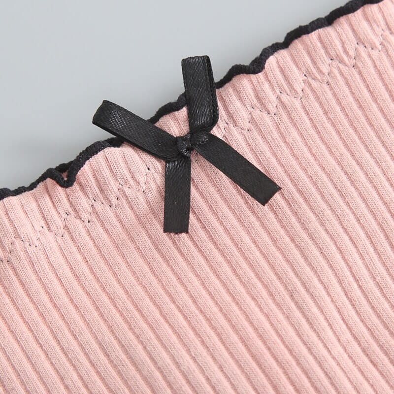 Close-up of women's cotton panty with a delicate black bow and ribbed texture, showcasing the stylish and comfortable design of these low-rise G-string panties.