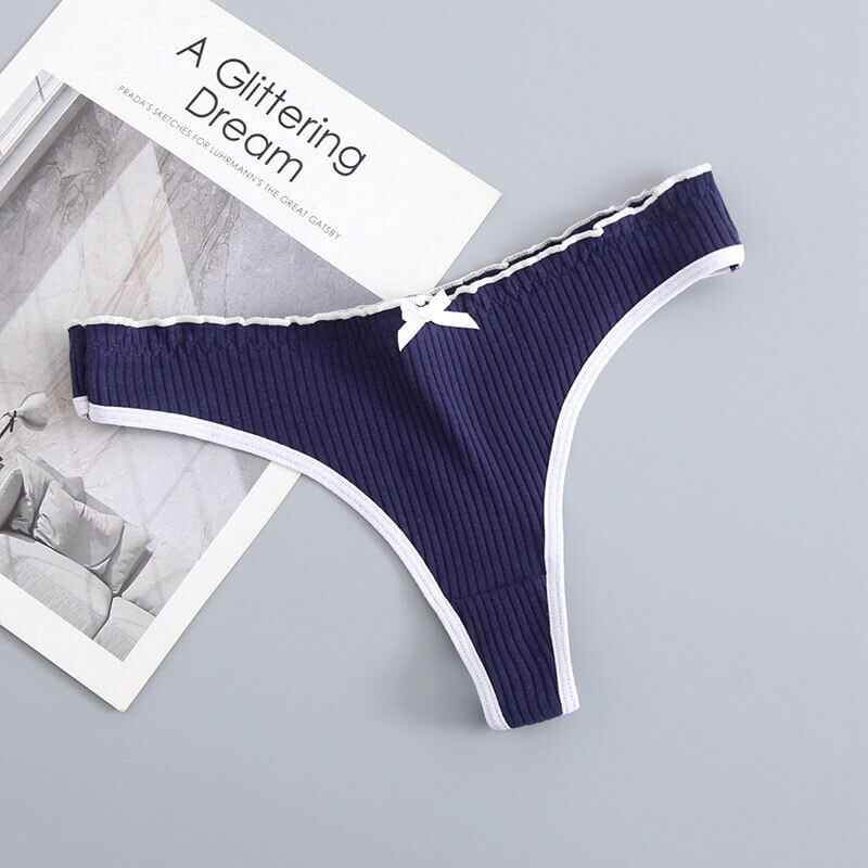 Women's navy low-rise T-back G-string panties with bow, cotton-spandex blend for comfort and style, featuring white trim.