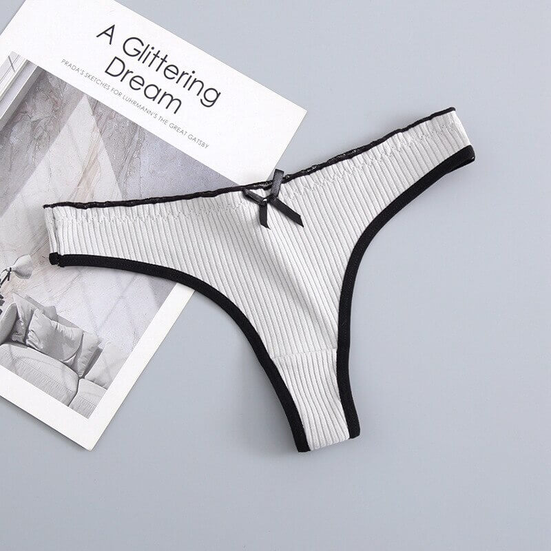 Women's low-rise T-back G-string cotton panties with bow, breathable and stylish design, featuring black trim for a modern look.