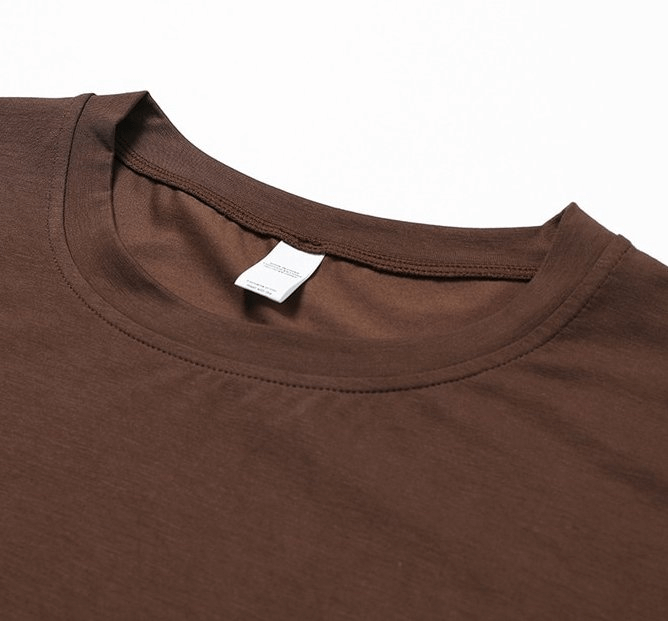 Close-up view of a chocolate brown women's cropped loose sports T-shirt with an O-neck collar, made from stretchy Nylon and Spandex fabric.
