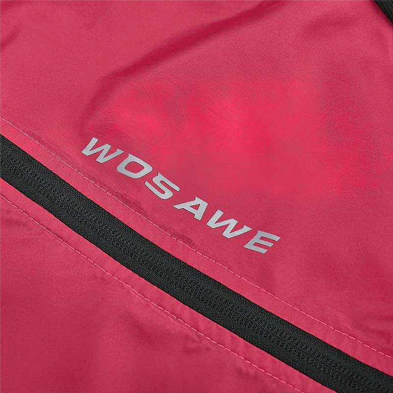 Close-up of red women's cycling windproof vest with reflective logo, showcasing breathable fabric and sleek design for visibility.