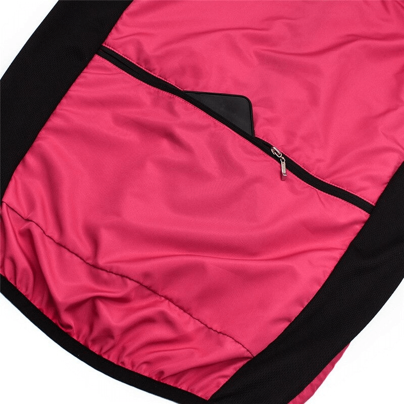 Close-up of women's cycling windproof vest with pink fabric and zip pocket, showcasing breathable design and reflective logo.