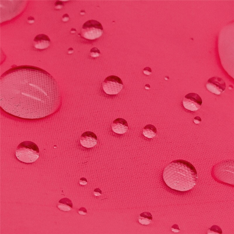 Close-up of water droplets on red windproof fabric showcasing durability and water resistance of women's cycling vest.