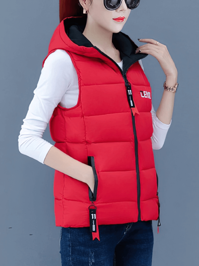 Stylish red women's down vest with hood and zipper pockets, perfect for chilly weather, featuring breathable cotton and polyester.