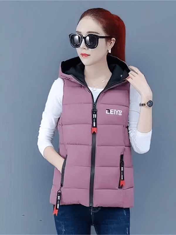 Woman wearing hooded Women's Down Vest with Zipper Pockets, stylish and warm, featuring breathable fabric and zippered closure.