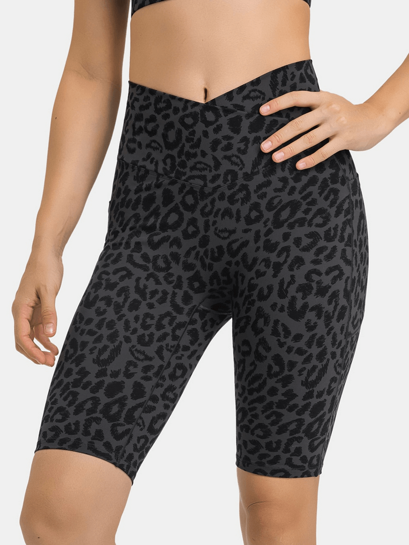 Women's elastic yoga shorts with leopard print, cross waist, and two deep pockets. Perfect for comfort and functionality during workouts.