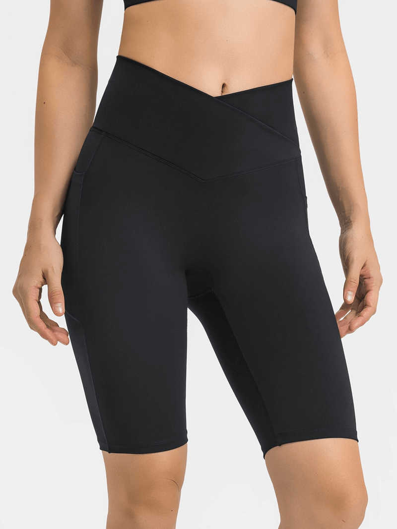 Women's elastic yoga shorts with cross waistband and two deep pockets in black, style SF1138, perfect for active comfort.