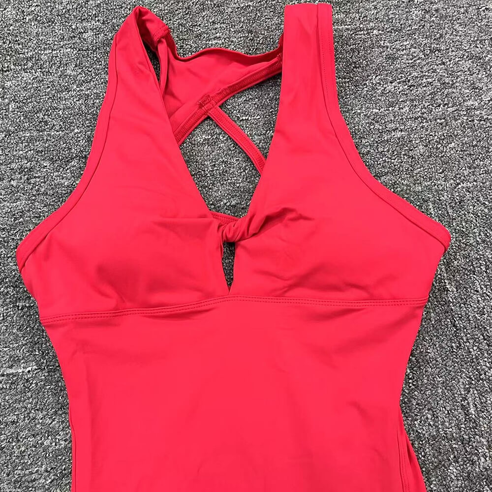 Women's red fitness jumpsuit with asymmetrical back design, lightweight Lycra, sleeveless for yoga workouts. Model SF1222