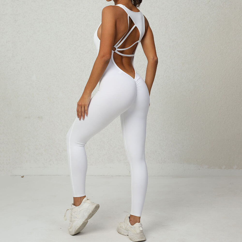 Woman modeling white fitness jumpsuit with asymmetrical back, showcasing sleek design and breathable fabric, ideal for yoga or workouts.