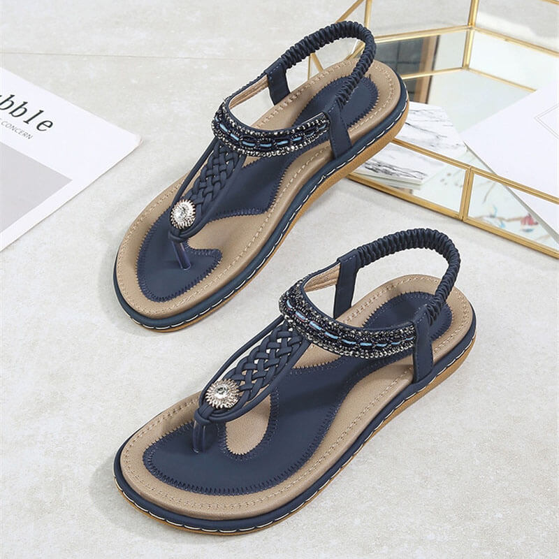 Women's flat gladiator sandals with crystal accents, featuring PU upper, floral pattern, elastic band, and cushioned insole – SF1064.