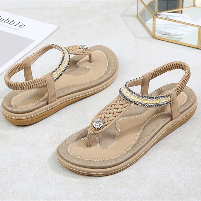 Women's flat gladiator sandals with crystal details, PU upper, elastic bands, and rubber outsole, stylish and comfortable.