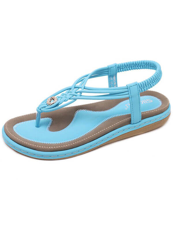Stylish women's flat gladiator sandal with turquoise PU upper, elastic band, and floral accents. Comfortable insole and durable rubber outsole.