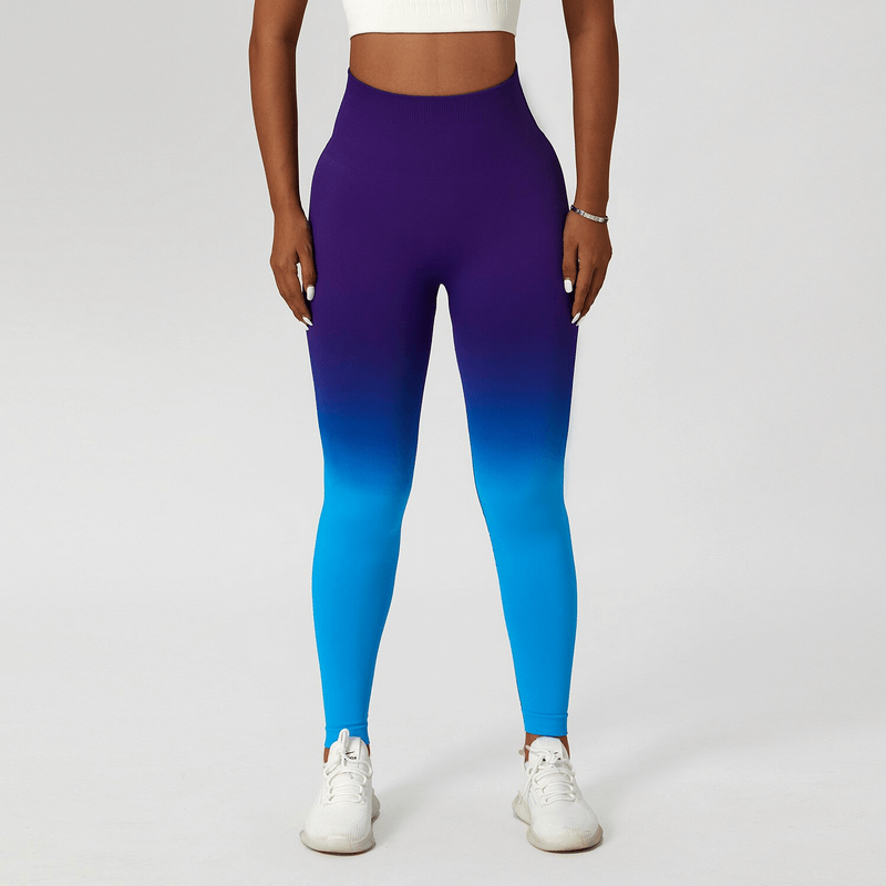 Woman wearing gradient seamless high waist yoga leggings in purple and blue.
