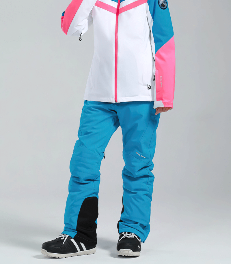 Women's high waist snow pants with pink and blue winter jacket, featuring waterproof zipper pockets, perfect for skiing adventures.