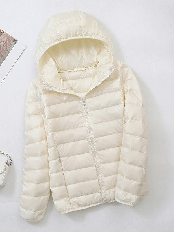 Women's lightweight down jacket with hood and zipper in cream color, ideal for warmth and style.
