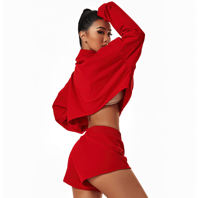 Woman wearing a red loose cropped sweatshirt designed for yoga and workouts, showcasing breathable cotton fabric and fashionable cut.
