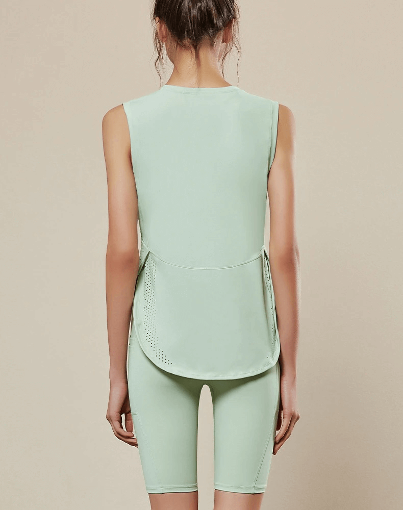 Woman wearing mint green loose mesh sleeveless yoga top, SF0139, showcasing breathability and comfort for optimal yoga performance.