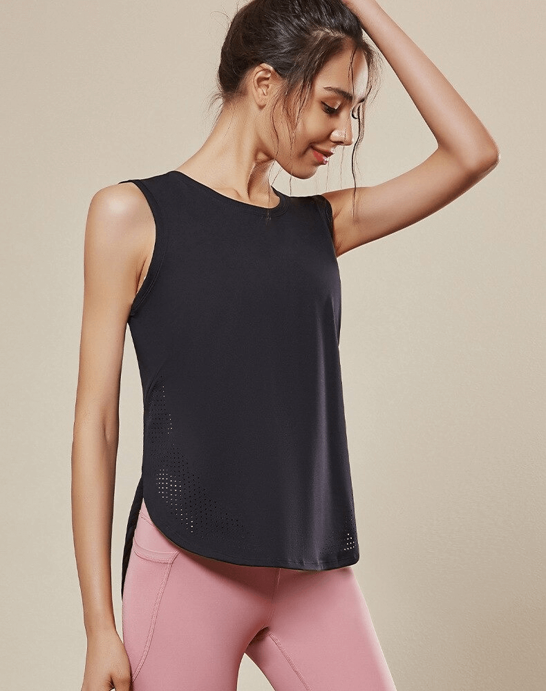 Woman in black sleeveless yoga top made of breathable mesh, perfect for performance and comfort, paired with pink leggings.