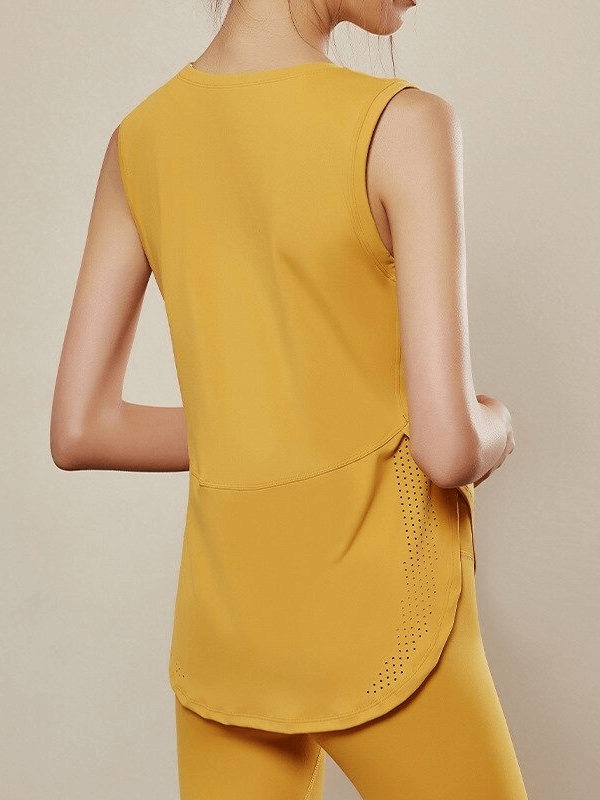 Woman wearing yellow sleeveless mesh yoga top, showcasing breathable fabric and loose fit for comfortable workouts.