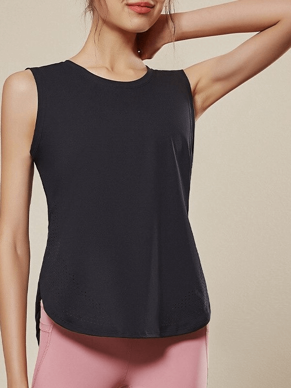 Woman wearing a black sleeveless breathable mesh yoga top, showcasing its loose fit and comfort.