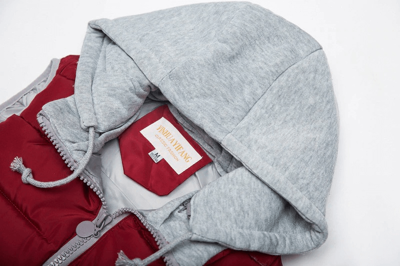 Women's red hooded vest with zipper and pockets, featuring a cozy grey hood for warmth in chilly weather.