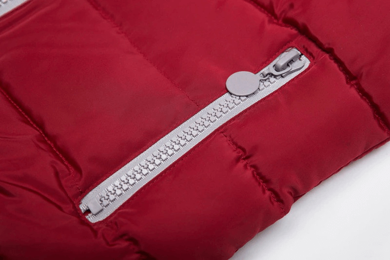 Close-up of red women's vest with hood, featuring a sleek zipper and solid pattern. Ideal for warmth in chilly weather. Model SF0071.