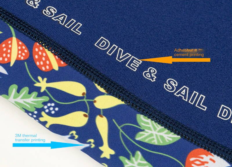 Colorful neoprene wetsuit fabric with visible Dive & Sail branding and thermal transfer printing details.