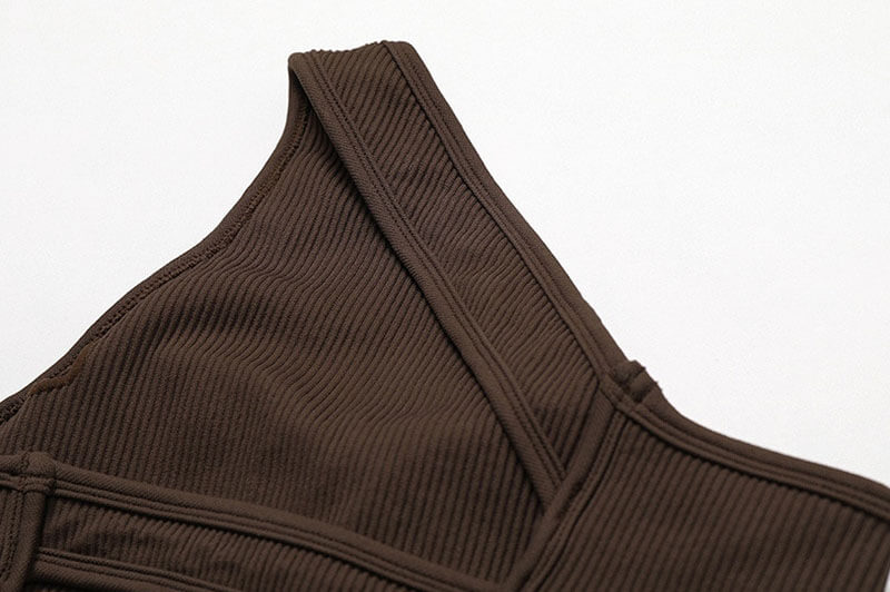 Close-up of a brown one-shoulder sports bra in breathable nylon spandex, ideal for fitness and activewear for women.