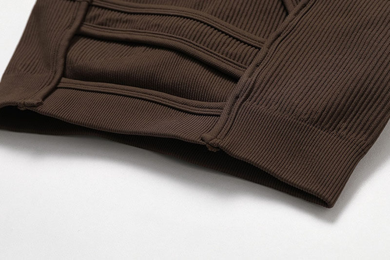 Close-up of brown ribbed women's sports bra showcasing breathable nylon-spandex fabric for fitness activities.