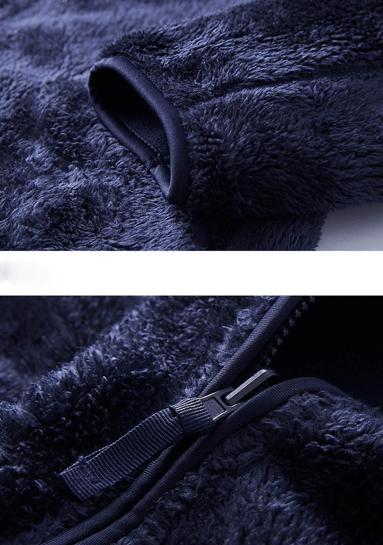 Close-up of blue reversible fleece jacket with stylish zipper and soft fabric texture, showcasing cuff detail.