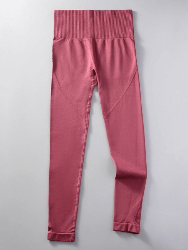 Women’s seamless high waist yoga leggings in pink, made from nylon and spandex for superior comfort and mobility.