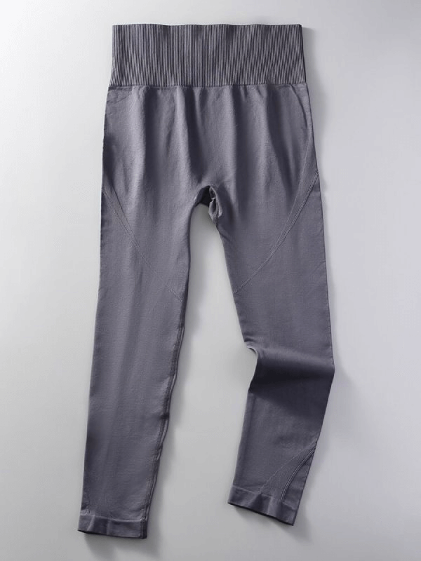 Gray women's seamless high waist yoga leggings made from nylon and spandex blend, full length with elastic waist for flexibility.