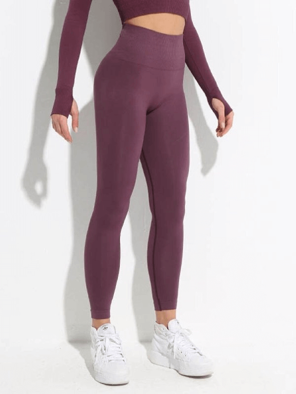 Woman wearing seamless high waist yoga leggings SF0126, showcasing comfort and flexibility in purple, perfect for yoga or active pursuits.