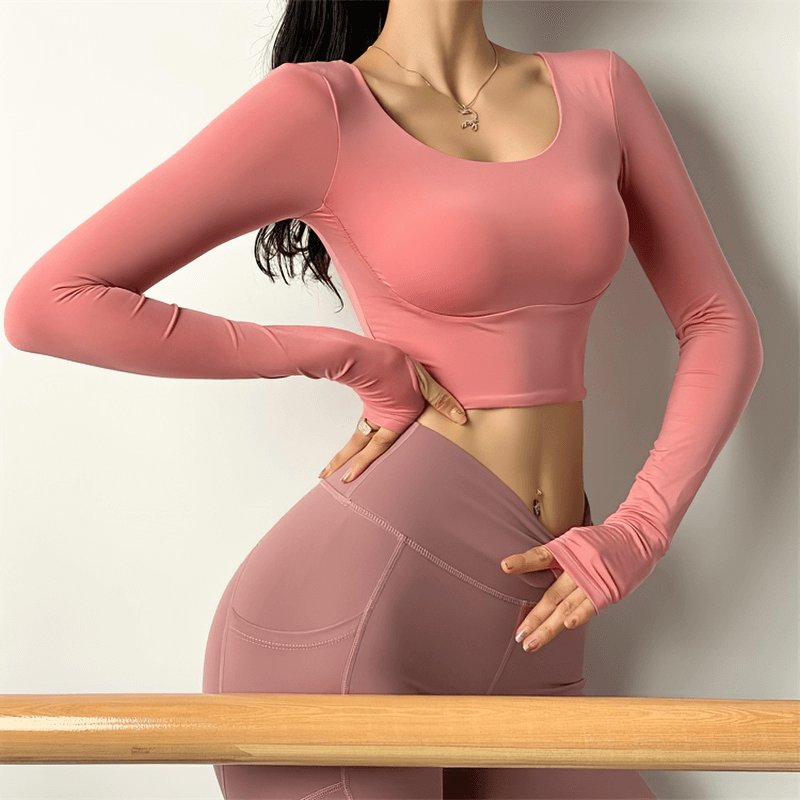 Women's sexy back long sleeves sports top in pink, high elastic gym wear for yoga and running, breathable polyester and nylon.