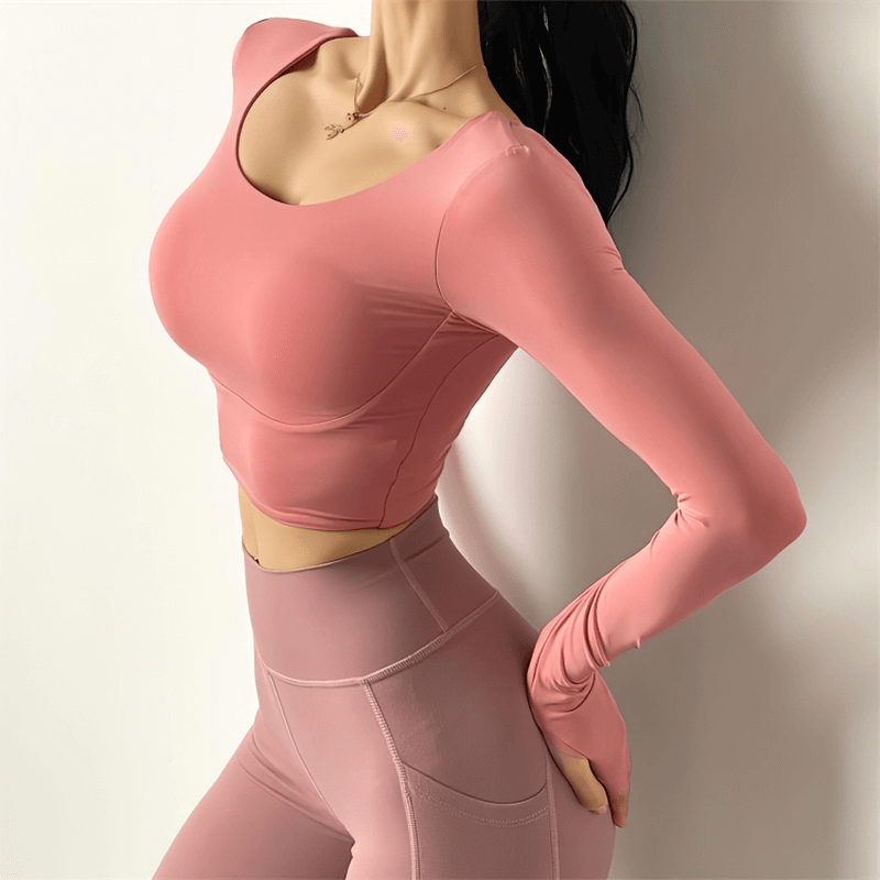 Women's sexy back long sleeves sports top in pink, perfect for yoga or running, showing high elasticity and comfort.