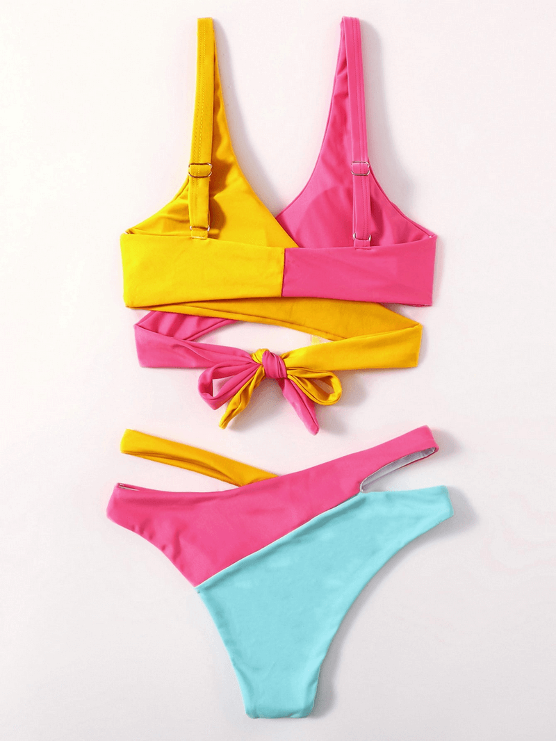 Vibrant pink, yellow, and blue women's split swimsuit with back tie and low waist, perfect for beach fashion.