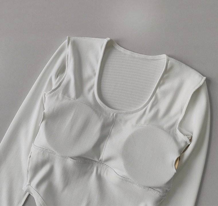 Women's white long sleeve yoga top with breathable fabric and snug fit, designed for superior comfort and style in yoga practice.